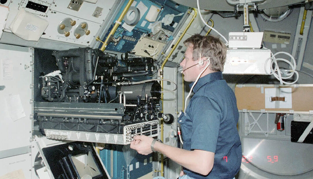 Payload Specialist Byron Lichtenberg working in the Spacelab on the Space Shuttle STS-009 mission in 1983
